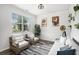 Bright living room with hardwood floors, modern furnishings and large windows with natural light at 7814 Messina Ct, Lithia Springs, GA 30122