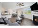 Open-concept living room features a cozy fireplace, modern furnishings, and seamless access to the kitchen and dining area at 7814 Messina Ct, Lithia Springs, GA 30122