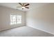 Comfortable bedroom featuring neutral carpet, ceiling fan, and natural light from a large window at 98 Coopers Glen Sw Dr, Mableton, GA 30126