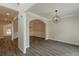 Elegant dining room with gray wood floors, decorative trim and a modern, decorative light fixture at 98 Coopers Glen Sw Dr, Mableton, GA 30126