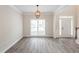 Dining room featuring new floors, modern lighting, and wainscoting at 98 Coopers Glen Sw Dr, Mableton, GA 30126