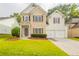 Charming two-story home featuring a well-manicured lawn and inviting entrance at 98 Coopers Glen Sw Dr, Mableton, GA 30126