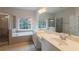 Well lit main bathroom with double sinks, soaking tub, and walk in shower at 98 Coopers Glen Sw Dr, Mableton, GA 30126
