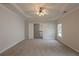 Spacious main bedroom with a tray ceiling, ceiling fan and carpet flooring at 98 Coopers Glen Sw Dr, Mableton, GA 30126