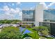 Exterior view of the property with a large building, landscaping, parking, and blue canopies at 230 E Ponce De Leon Ave # 324, Decatur, GA 30030