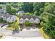 Aerial view of the townhouses, showing front parking, landscaping, and surrounding trees at 2566 Walden Lake Dr, Decatur, GA 30035
