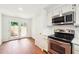 Bright kitchen features stainless steel appliances and access to a charming outdoor patio at 30 Dunwoody Springs Dr, Atlanta, GA 30328