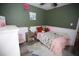 bedroom featuring a bed with butterfly-themed bedding and a pink accent at 3227 Due West Rd, Dallas, GA 30157