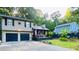 Charming split-level home featuring a two-car garage and inviting front porch nestled among lush trees at 3227 Due West Rd, Dallas, GA 30157
