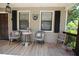 Inviting front porch featuring comfortable seating, neutral rug, and a welcoming 'hello' sign at 3227 Due West Rd, Dallas, GA 30157