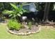 Beautifully landscaped yard with unique barrel water feature, lush greenery, and decorative accents at 3227 Due West Rd, Dallas, GA 30157