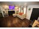 Cozy living room featuring hardwood floors, fireplace, flat-screen TV and stylish decor at 3227 Due West Rd, Dallas, GA 30157