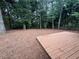 Large backyard featuring a wooden deck with a fenced in yard and mature trees at 525 Cherokee Overlook Ct, Canton, GA 30115