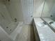 Bright bathroom with a tub, tile floor, and neutral walls at 525 Cherokee Overlook Ct, Canton, GA 30115
