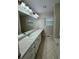 Bathroom featuring a white vanity with a long countertop, a large mirror, and a window at 525 Cherokee Overlook Ct, Canton, GA 30115