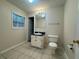 Bathroom with a large mirror, white vanity, and plenty of natural light from the window at 525 Cherokee Overlook Ct, Canton, GA 30115