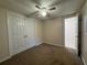 Bedroom with carpet, neutral walls, ceiling fan, and a closet with double doors for ample storage at 525 Cherokee Overlook Ct, Canton, GA 30115