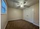 Cozy bedroom featuring neutral paint, carpet floors, a ceiling fan, and double door closet at 525 Cherokee Overlook Ct, Canton, GA 30115