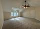 Large carpeted bedroom with ceiling fan and plenty of natural light at 525 Cherokee Overlook Ct, Canton, GA 30115