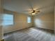 Spacious carpeted bedroom with natural light and ceiling fan at 525 Cherokee Overlook Ct, Canton, GA 30115