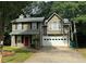Charming two-story home featuring a two-car garage, red front door, and well-manicured lawn at 525 Cherokee Overlook Ct, Canton, GA 30115