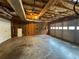 Unfinished garage featuring exposed rafters, ample space, and a large door for easy vehicle access at 525 Cherokee Overlook Ct, Canton, GA 30115
