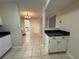 Bright kitchen featuring tile floors, white cabinets, and an open layout flowing into other rooms at 525 Cherokee Overlook Ct, Canton, GA 30115