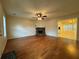 Bright living room with a stone fireplace, hardwood floors, and an adjacent dining area at 525 Cherokee Overlook Ct, Canton, GA 30115