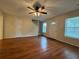 Inviting living room with hardwood floors, a ceiling fan, and an entrance to the stairway at 525 Cherokee Overlook Ct, Canton, GA 30115
