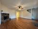 Spacious living room featuring hardwood floors, stone fireplace, and modern ceiling fan at 525 Cherokee Overlook Ct, Canton, GA 30115