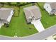 Aerial view of home on spacious lot with large, green lawn, two-car garage, and fenced backyard at 6825 Rambling Vale, Cumming, GA 30028