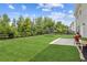Spacious backyard features lush lawn, black fencing and patio, perfect for outdoor activities and entertaining at 6825 Rambling Vale, Cumming, GA 30028