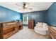 Cozy bedroom with carpet, ceiling fan, and window allowing natural light in at 6825 Rambling Vale, Cumming, GA 30028