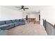 Open concept bonus room with carpeting, railing, and large sofa at 6825 Rambling Vale, Cumming, GA 30028