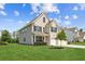 Well-maintained two-story home with lush green lawn, two-car garage, and attractive landscaping at 6825 Rambling Vale, Cumming, GA 30028
