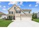 Beautiful two-story home featuring a two-car garage, brick facade, and a well-manicured front lawn at 6825 Rambling Vale, Cumming, GA 30028