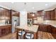 Stylish kitchen with stainless steel appliances, center island with seating, and ample cabinet space at 6825 Rambling Vale, Cumming, GA 30028