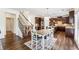 Spacious kitchen and dining area with wooden accents, stainless steel appliances, and a staircase at 6825 Rambling Vale, Cumming, GA 30028