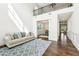 Bright living room with soaring ceilings, hardwood floors, and a view into the dining room at 6825 Rambling Vale, Cumming, GA 30028