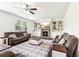 Cozy living room with a stone fireplace, built-in bookshelves, and comfortable seating at 6825 Rambling Vale, Cumming, GA 30028