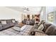 Open living space with comfortable seating, a large window, and views to the kitchen area at 6825 Rambling Vale, Cumming, GA 30028