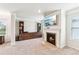 Living room with white trim, fireplace, carpeting, television, built-ins and windows at 6825 Rambling Vale, Cumming, GA 30028