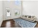 Inviting living room featuring hardwood floors, and neutral decor; door with a decorative wreath is shown at 6825 Rambling Vale, Cumming, GA 30028