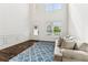Bright living room featuring hardwood floors, neutral decor, and two story ceilings at 6825 Rambling Vale, Cumming, GA 30028