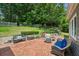 Charming backyard with a brick patio, seating area, and lush landscaping at 747 Channing Nw Dr, Atlanta, GA 30318