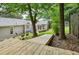 Backyard showcasing a wooden deck and patio surrounded by lush landscaping and a fenced perimeter at 747 Channing Nw Dr, Atlanta, GA 30318