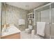 Cozy bathroom featuring wallpaper, a sleek vanity, and a glass shower enclosure at 747 Channing Nw Dr, Atlanta, GA 30318