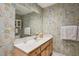 Bathroom featuring a vanity, large mirror, and beach themed wallpaper at 747 Channing Nw Dr, Atlanta, GA 30318