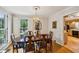Bright dining room with hardwood floors and a chandelier, open to the adjacent kitchen area at 747 Channing Nw Dr, Atlanta, GA 30318