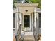 Welcoming front door framed by white columns and iron railings leading to the front entrance at 747 Channing Nw Dr, Atlanta, GA 30318